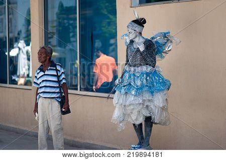 Havana, Cuba - July 2014:  Living statue of a cuban woman with a fairy custome in a scene at Obispo Street at havana