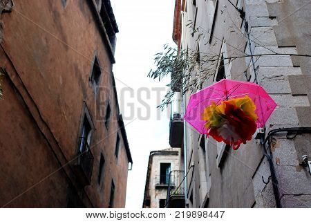 Pink umbrella at the barri vell at Girona