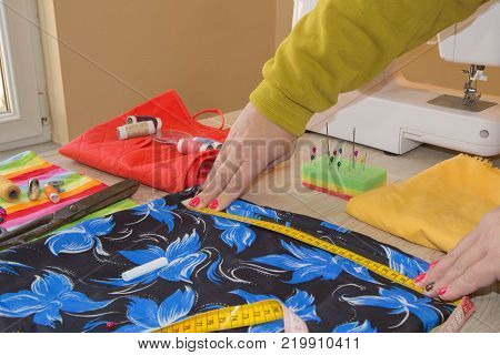 Tailor Woman working in his tailor shop Tailoring. Tailor working at the studio. woman's hand sew cloth. Handmade. hands of female by needlework