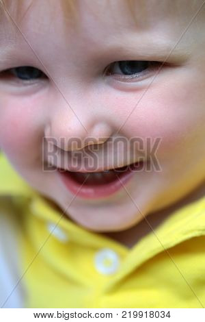 Baby boy smile with blue eyes on happy face and blond hair on natural environment. Child childhood family. Happiness innocence infancy future concept