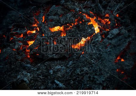 Magma textured molten rock surface. Lava flame on black ash background. Danger hazard energy concept. Volcano fire crust. Formation geology nature environment.