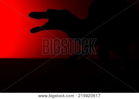 spinosaurus shadow with red light in dark