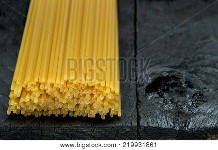 Spaghetti noodle on dark rustic wood picture