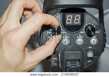 hand adjusts the flash light candlestick behind
