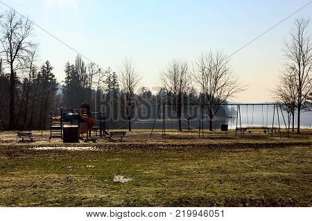 morning sun on winter play area with lake