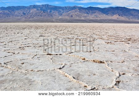 Crinkly salt flats of constantly evaporating bed of salty, mineralized water at the Badwater Basin in the Death Valley National Park in USA.