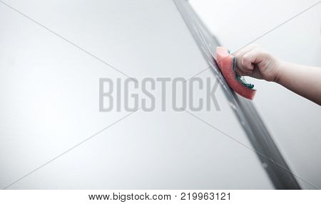 Cute little girl drawing on blackboard. Toddler girl having fun outdoors, holding chalk and drawing.