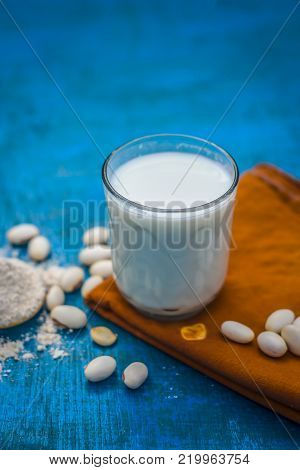 Close Up Of Ayurvedic Herb Kuanch,cowhage,mucuna Pruriens With Powder And Milk Glass.;