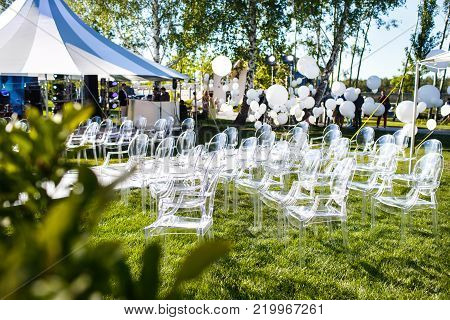 Outdoor wedding ceremony in the forest with large balls.