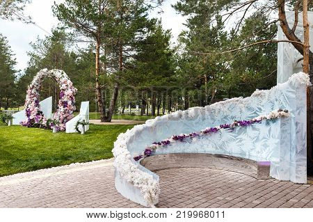 Outdoor wedding ceremony with umbrellas in the forest.