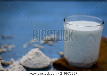 Close Up Of Ayurvedic Herb   Satavari,asparagus Racemosus With Its Powder And Root With Milk Glass.