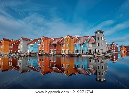 Colourful wooden housings in wintertime at Reitdiephaven in Groningen, The Netherlands