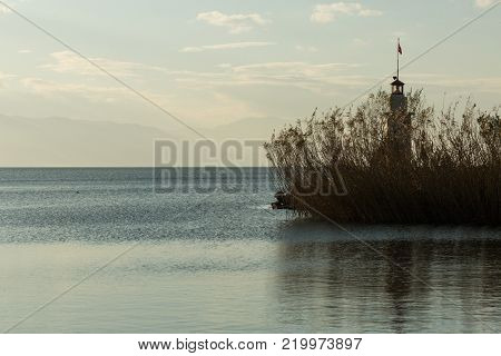 lighthouse surrounded by reeds on the calm and peaceful Lake Iznik, Iznik, Turkey