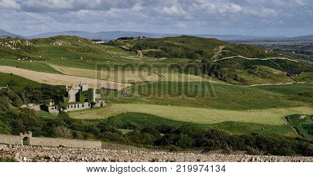 The ruins of Clifden Castle on the sloping meadows near Clifden in the Connemara region of county Galway, Ireland.