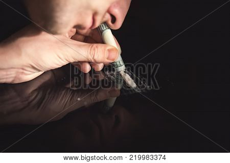 Junkie Is Snorting Cocaine Powder With Rolled Banknote.