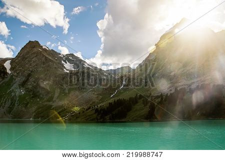 Bright Sunlight Shines From Behind The Mountain.