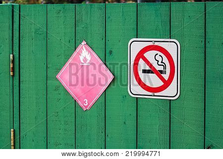 No smoking next to a flammable category 3 hazard sign.