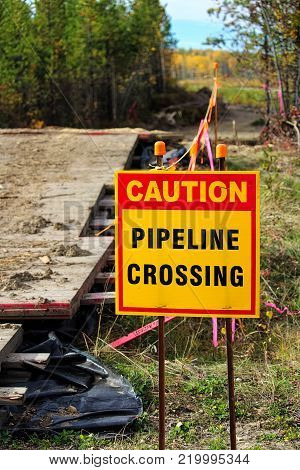 Closeup of a caution pipeline crossing sign.