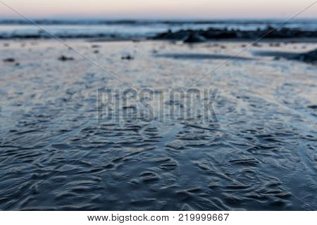 Wrinkles in Sandy Surface  from Receding Tide