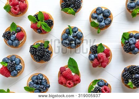 Useful Tartlets With Blueberries, Blueberries, Raspberries In The Shape Of A Heart Isolated On White