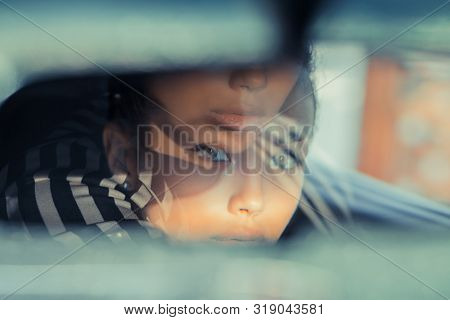 Beautiful Woman Driver Reflecting In The Rear View Mirror. Driving Her Car Concept. Artistic Shot Wi