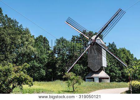 Bokrijk, Belgium - June 27, 2019: Windmill Of Schulen Is Set In Green Environment Of Meadow And Surr