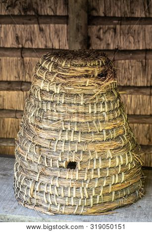Bokrijk, Belgium - June 27, 2019: Closeup Of Classic Large Yellowish-brown Straw Beehive Set Under A