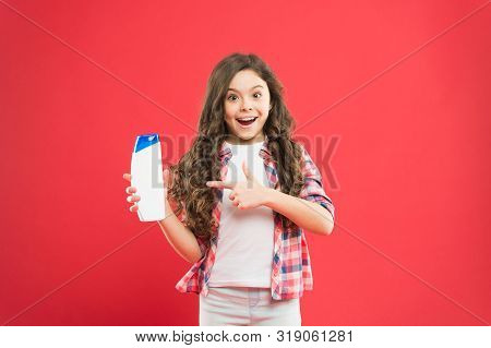 The Best Soap For Kids Skin. Small Child With Long Curly Hair Pointing Finger At Soap On Red Backgro