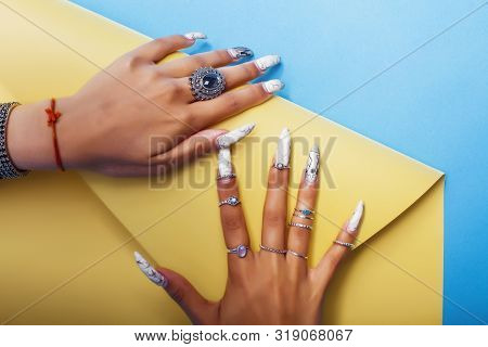 Woman Hands Holding Colorful Paper Copyspace Wearing A Lot Of Jewelry And Long Nails Closeup