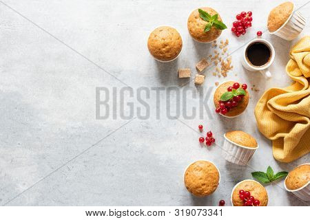 Fresh Muffins Or Cupcakes With Papercups. Top View, Copy Space. Grey Concrete Background. Sweet Bake