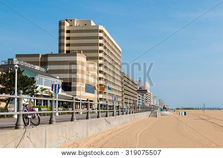Virginia Beach, Virginia/usa - July 13, 2017:  Hotels Line The Oceanfront And A Purple Bike Rests On