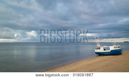 Fishing Boat On Baltic Sea Coast. Stormy Weather. Mechelinki, Poland, Pucka Bay.