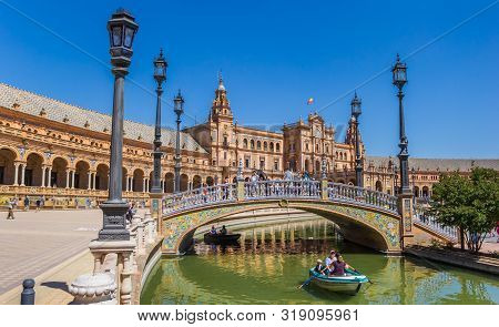 Sevilla, Spain - May 14, 2019: Tourists Enjoying A Boat Ride In The Canals Of The Plaza Espana In Se