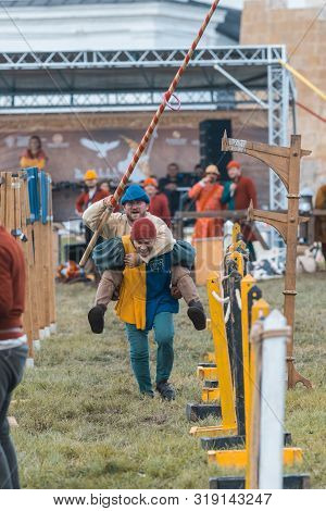 Bulgar, Russia 11-08-2019: Two Buffoons Having Fun On The Battlefield On Medieval Festival - Holding