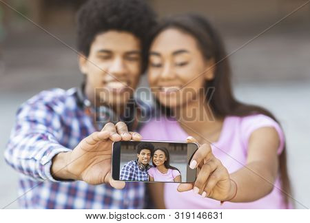 Capturing Happy Moments. Young Loving Couple Making Selfie On Smartphone Camera, Selective Focus On 
