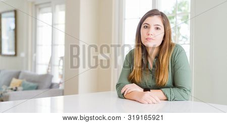 Beautiful young woman at home Relaxed with serious expression on face. Simple and natural looking at the camera.