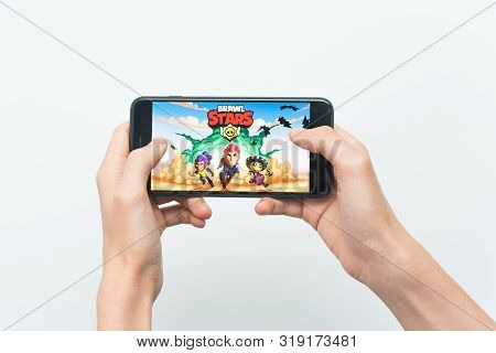 Samara, Russia -07, 29, 2019: A Young Guy Playing Brawl Stars Game On Iphone 8 Plus. Teenage Boy Hol