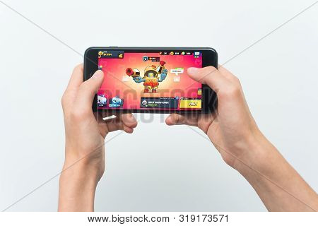 Samara, Russia -07, 29, 2019: A Young Guy Playing Brawl Stars Game On Iphone 8 Plus. Teenage Boy Hol