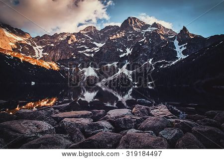Breathtaking View To The Beautiful Mountains With Mirroed Reflection And Clouds At Sunset Time.
