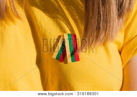 Small Lithuanian Flag Ribbon On Woman Chest