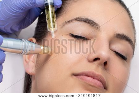 Close Up Of Young Woman Having Cosmetic Mesotherapy Facial. Therapist Injecting Pharmaceuticals With