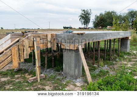 Reinforced Concrete Slab In The Shape Of A Rectangle On Concrete Poles. Visible Formwork And Buildin