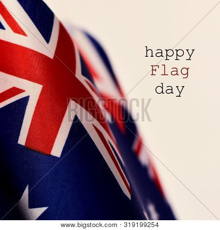 closeup of some australian flags and the text happy flag day against a beige background