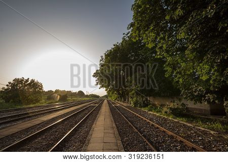 Railway Tracks, Rails And Platforms In A Rural Train Station In Alibunar, Serbia, Taken During Sunse