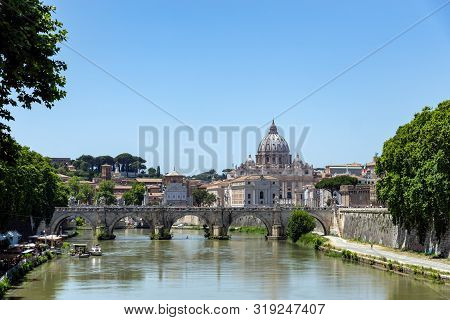 View Of Santangelo Bridge Over The Tiber River With St. Peters Basilica In Background - Rome, Italy