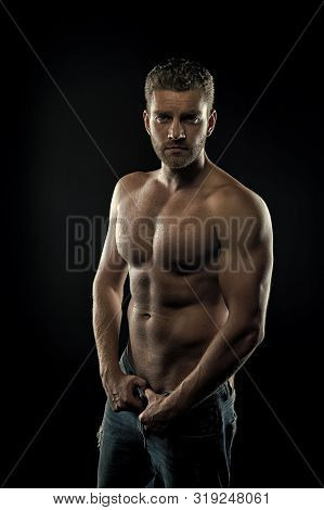 On The Way To Great Shape. Man Muscular Torso Tense Muscles Holds Denim Pants. Macho Muscular Chest 