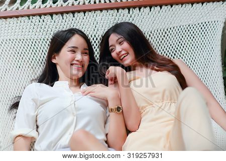 Young And Cute Asian Women Lying In A Hammock During Holiday