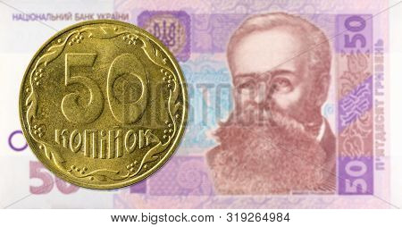 50 Ukrainian Kopiyka Coin Against 50 Ukrainian Hryvnia Banknote Indicating Growing Economics With Co