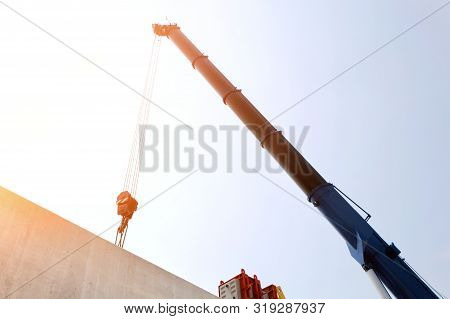 Tower Crane With Guideway Beam On Blue Sky As A Background In The Construction Site, Space For Text 