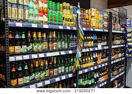 Minsk, Belarus - August 24, 2019: Many Bottles Of Beer Of Different Brands Show On A Shelf For Sale 